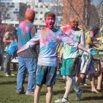 HOLI 2016 male student smiling in front of clock tower